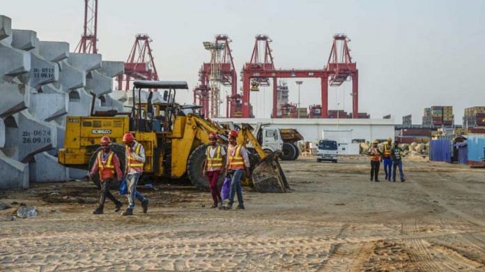 (Representational image) Workers walk past excavators at the site of Colombo Port City, developed by China Harbour Engineering Co | Atul Loke | Bloomberg