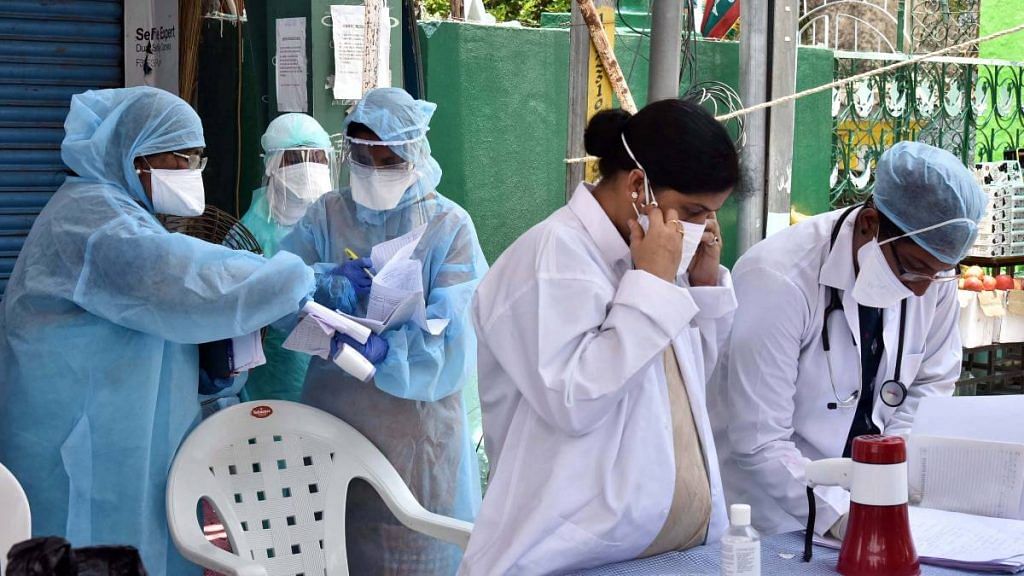 Health workers wearing PPEs wait for the visit of COVID-19 central team at containment zone in April 2020 | ANI File Photo