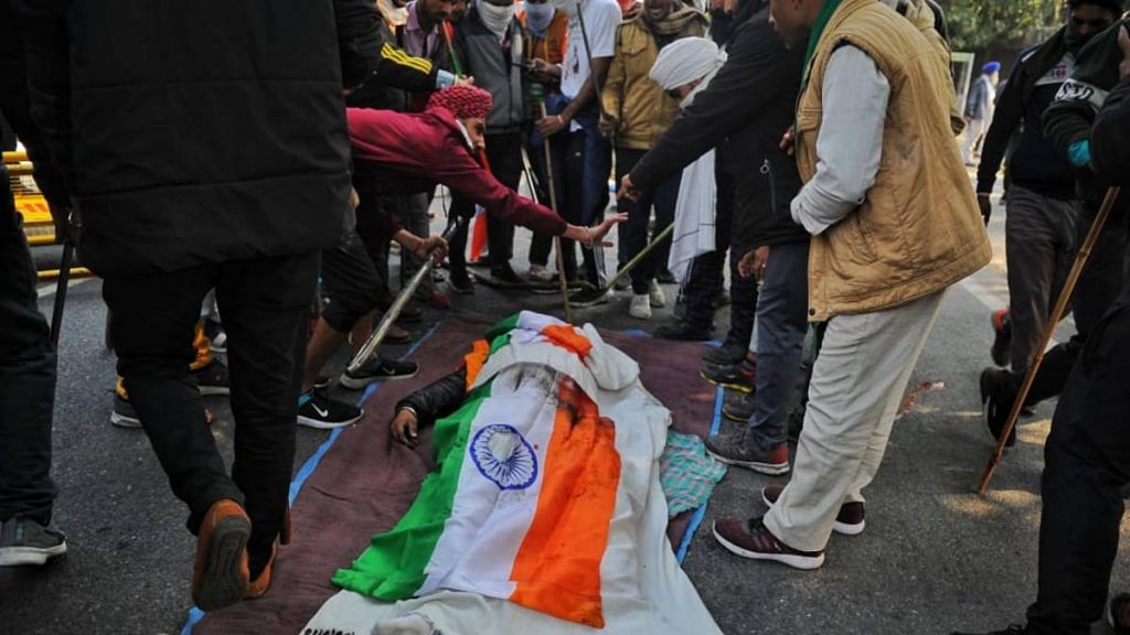 Protesters gathered around the body of a farmer who died during the tractor rally that turned violent on Republic Day in New Delhi on 26 January 2021 | Suraj Singh Bisht | ThePrint