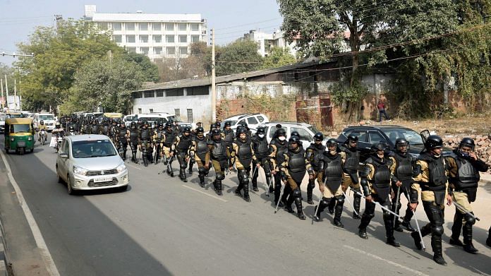 Haryana Police personnel conduct a march ahead of farmers' tractor rally, in Gurugram on 25 January