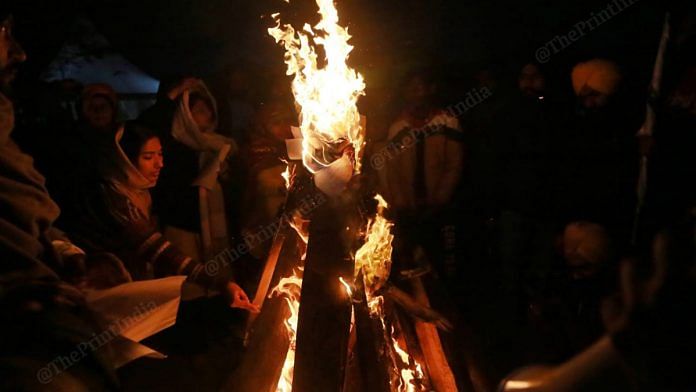 Farmers burnt copies of the three contentious farm laws during Lohri celebrations at Singhu border Wednesday | Photo: Manisha Mondal | ThePrint