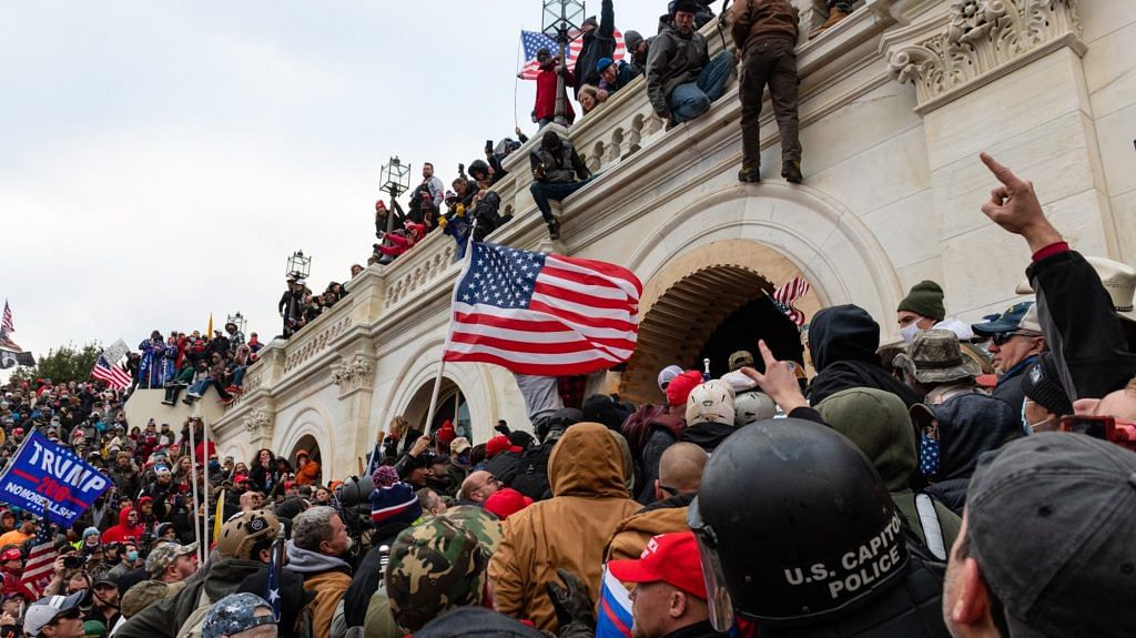 Demonstrators attempt to enter the US Capitol building during a protest in Washington, DC on 6 January | Photo: Eric Lee | Bloomberg