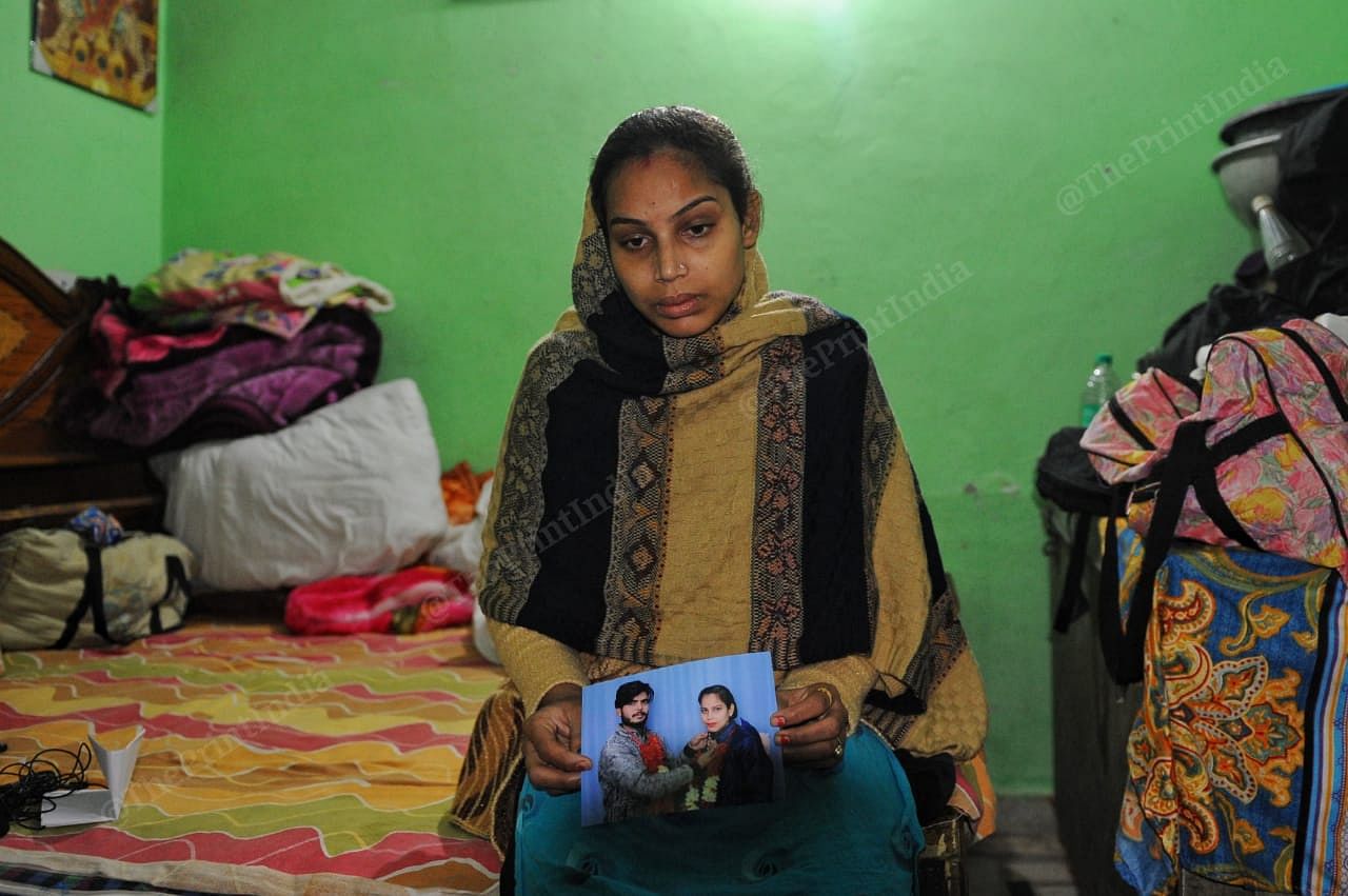 Komal holds up their wedding photo | Photo: Suraj Singh Bisht