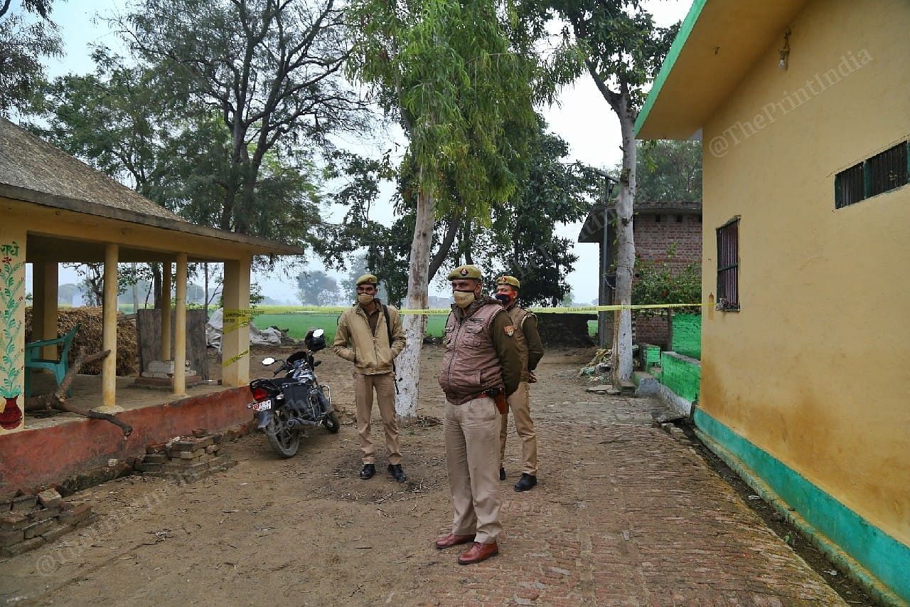 Budaun police personnel near the alleged crime scene in village Mevali | Suraj Singh Bisht | ThePrint