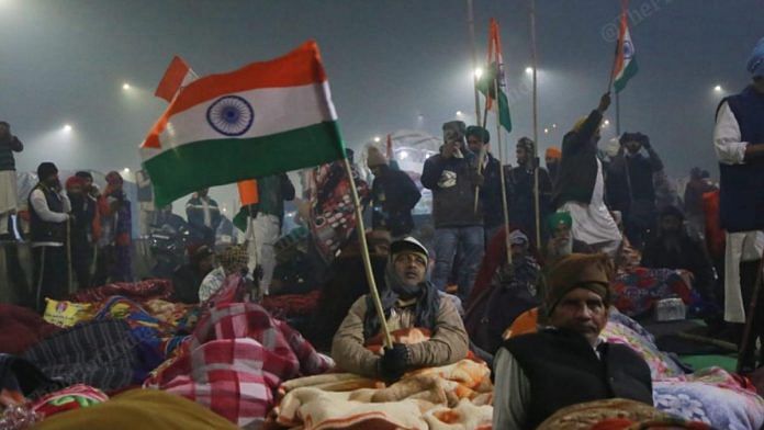 A protestor wave national flag at Ghazipur protest site | Photo: Manisha Mondal | ThePrint