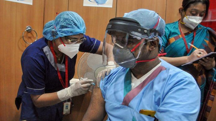 A medic administers the Covid-19 vaccine to a frontline worker, after the virtual launch of the vaccination drive by Prime Minister Narendra Modi, at AMRI-Dhakuria hospital, in Kolkata, Saturday, Jan. 16, 2021. | PTI
