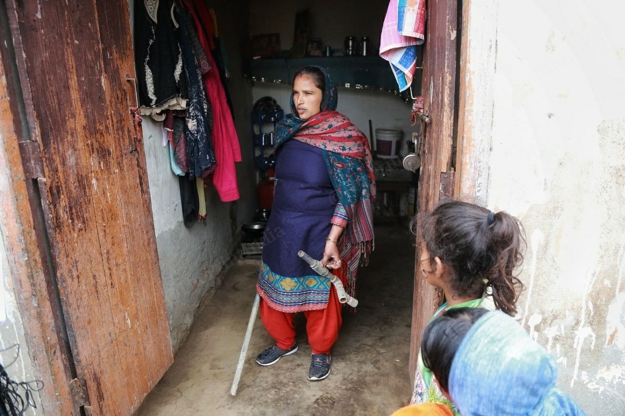 A woman shows old pipes that have been replaced with new ones in Ballahi village, Kurukshetra | Manisha Mondal | ThePrint