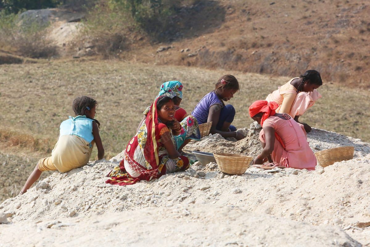 Vasanti, 21, collects scraps of mica, called dhibra, in Devanjot village in Giridih with a group of young women and girls | Photo: Praveen Jain | ThePrint