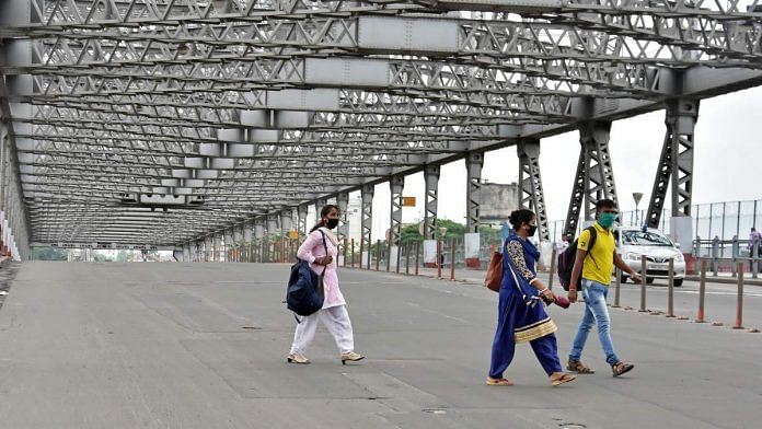 Representational image of people walking across West Bengal's iconic Howrah Bridge | File photo: ANI