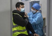 A Chinese health care worker gives a Covid-19 vaccine shot to a man at a mass vaccination center for Chaoyang District on 15 January 2021 in Beijing, China | Kevin Frayer | Getty Images via Bloomberg