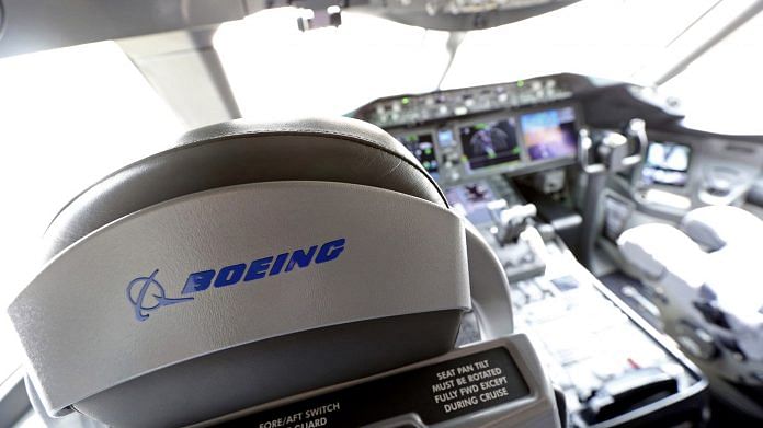 A logo sits on a pilot's seat in the cockpit of a Boeing Co. 787 Dreamliner | Photo via Bloomberg