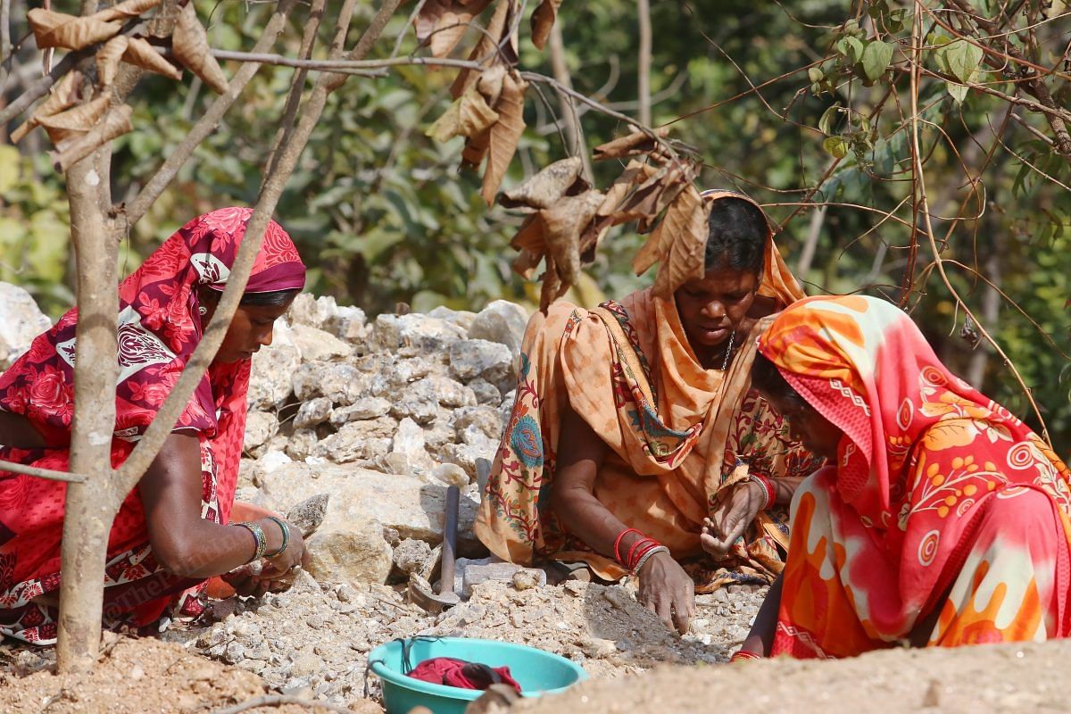 Women break through rocks to extract pieces of mica in a mine near Kararitola village in Koderma district | Photo: Praveen Jain | ThePrint