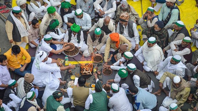 Farmers perform a puja on the occasion of Basant Panchami during their agitation against new farm laws, at Ghazipur border on 16 February | Photo: PTI