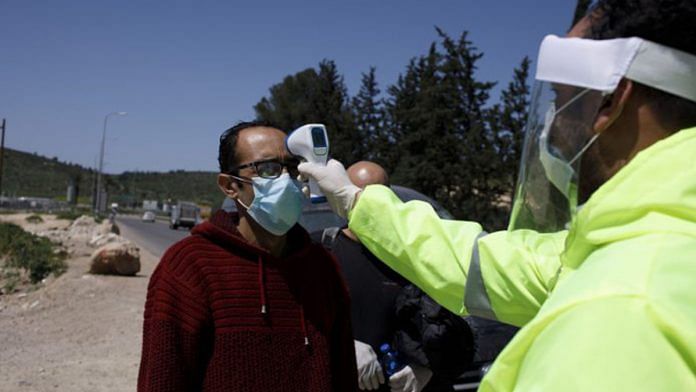 A municipal worker takes the temperature reading of a worker in Jerusalem (representational image) | Photo: Kobi Wolf | Bloomberg