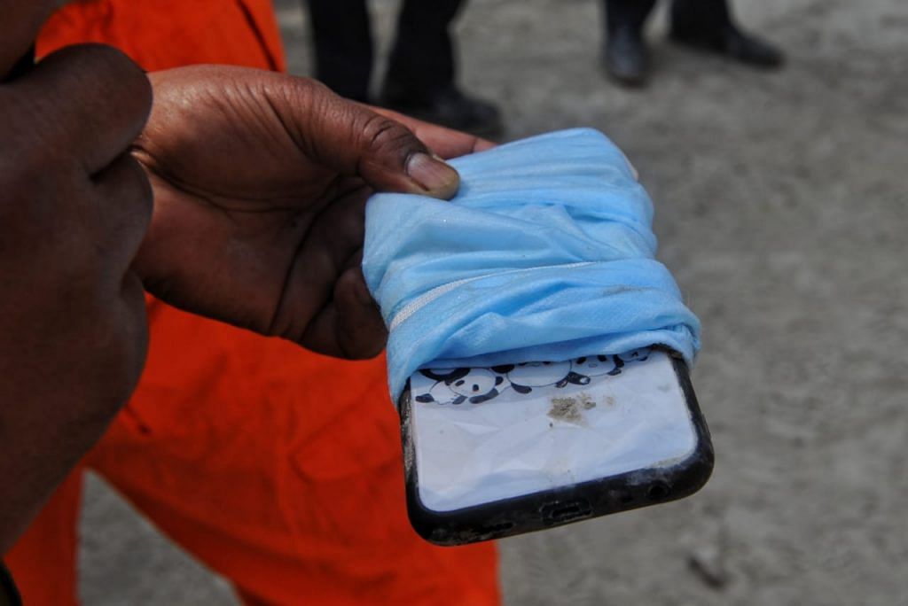 A phone recovered at the Rishi Ganga hydel project site in Raini village.