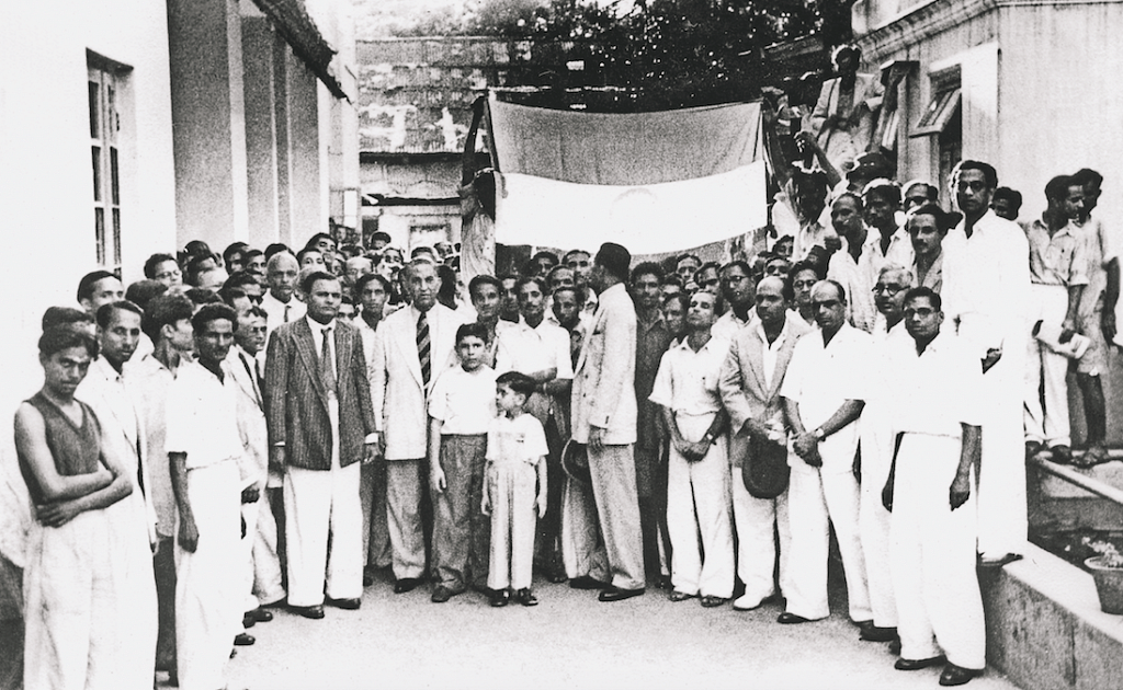 The young Hameid brothers, Yusuf and Muku, join their father and Cipla staff at a flag hoisting ceremony in the company's Bombay premises, 15 Aug 1947 |© Cipla Limited 