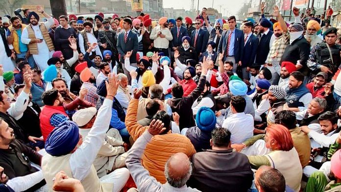 SAD President and former Punjab Deputy CM Sukhbir Singh Badal sits on a dharna along with Akali supporters after a clash, at the tehsil office in Jalalabad, on 2 February, 2021 | PTI