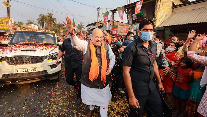 Union Home Minister Amit Shah waves at party workers during a roadshow in Namkhana, South 24 Paraganas, Thursday, Feb. 18, 2021. | PTI