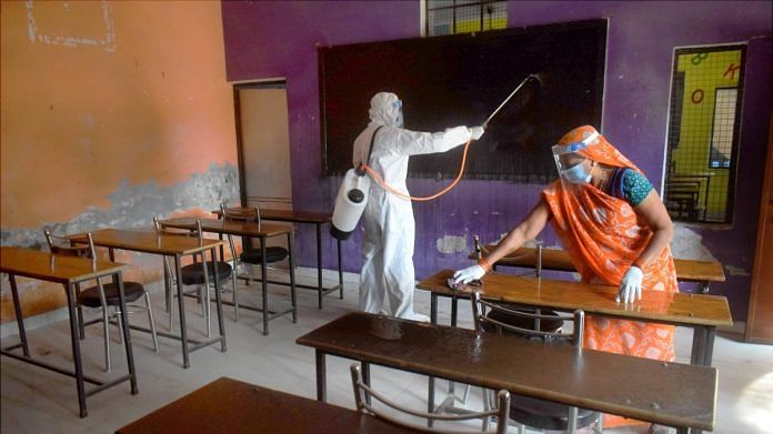 Workers sanitize a classroom ahead of reopening of schools for 6 to 8 standard students in UP's Prayagraj, on 6 February, 2021 | Representational image | PTI