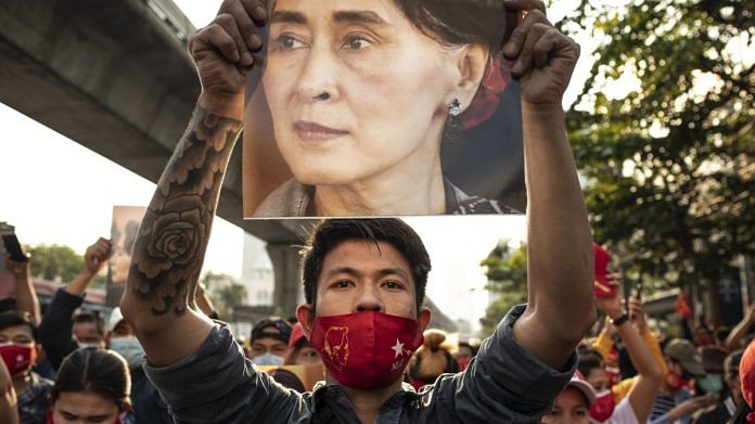 People hold up signs of Aung San Suu Kyi to protest the Myanmar Military coup outside of the Myanmar Embassy in Bangkok, Thailand | Photographer: Andre Malerba/AFP/Getty Images via Bloomberg
