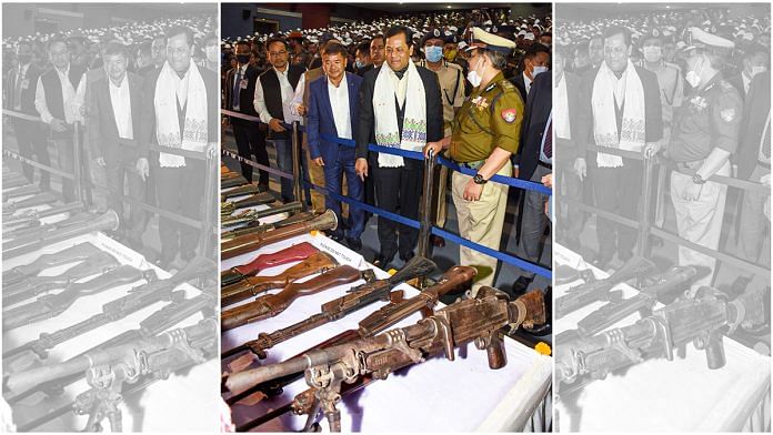 Assam Chief Minister Sarbananda Sonowal looks at arms and ammunition laid out by five militants outfits of Karbi-Anglong, during an arms laying down ceremony at Srimanta Sankardev Kalashetra in Guwahati, on 23 February | PTI