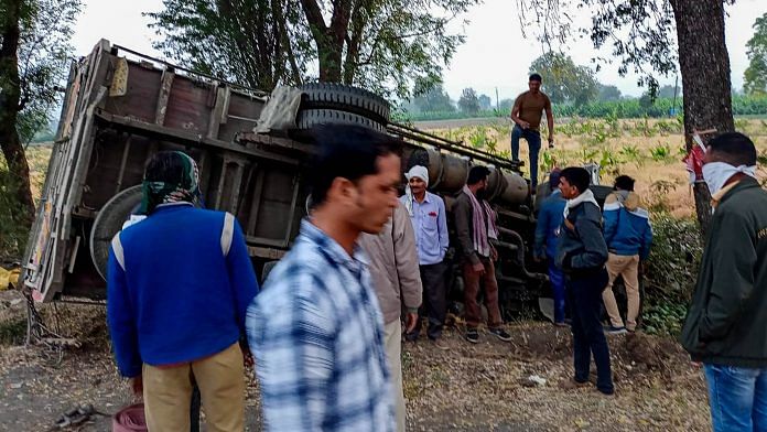 People gather near the mangled remains of a truck after it overturned near Kingaon village, killing atleast 16 labourers, in Jalgaon district of Maharashtra, Monday, Feb. 15, 2021. | PTI