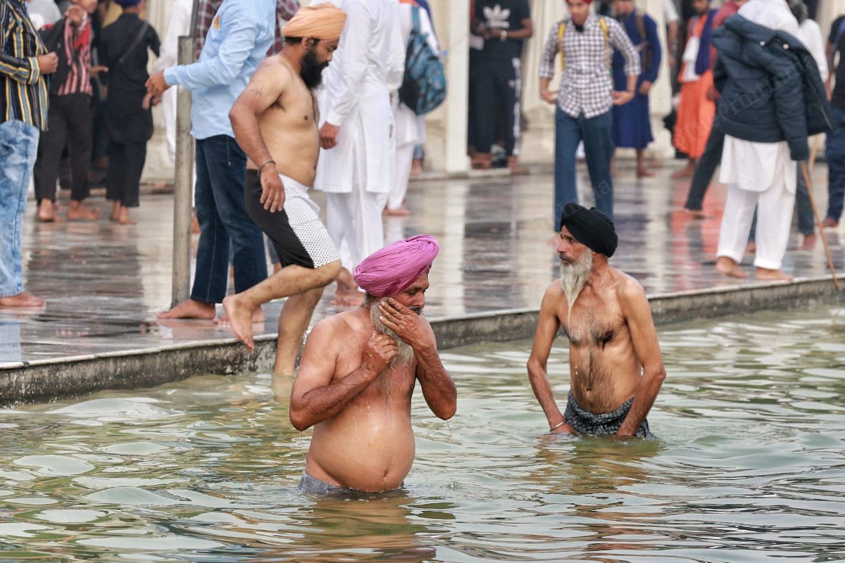 Many senior citizens took a dip in the river Sarovar as part of the festivities | Photo: Manisha Mondal | ThePrint