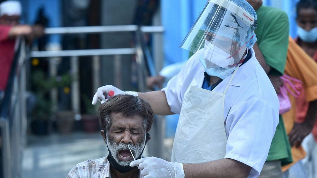 A health worker collects a swab sample for a Covid test, near Kashmere Gate in New Delhi, on 20 March 2021 | Representational image | PTI