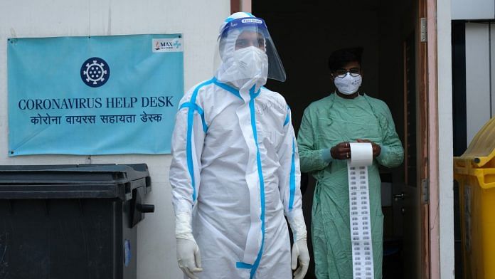 Medical workers in PPE outside a coronavirus help desk at the Max Smart Super Specialty Hospital in New Delhi (File photo) | Photographer: T. Narayan | Bloomberg