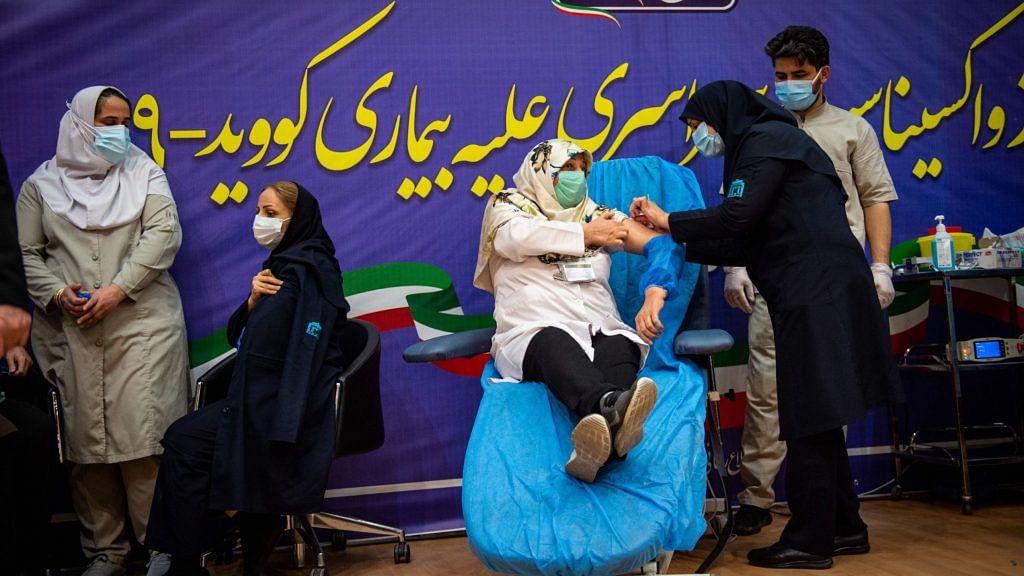 A medical worker administers a dose of Russia's Sputnik V vaccine at the Imam Khomeini hospital in Tehran, Iran, on Tuesday, Feb. 9, 2021. | Photographer: Ali Mohammadi | Bloomberg