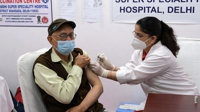 A health worker administers the Covishield vaccine to a senior citizens at Rajiv Gandhi Super Speciality Hospital in New Delhi | T.Narayan | Bloomberg