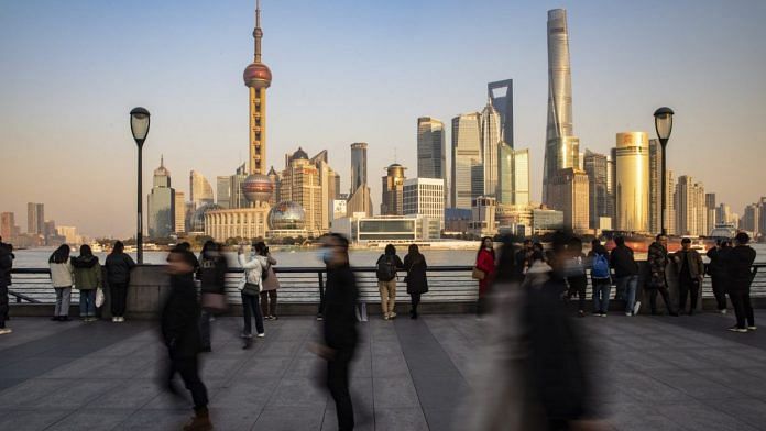 File photo | Visitors walk on the Bund in Shanghai, China | Qilai Shen/Bloomberg