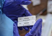 A healthcare worker checks test strips at a rapid-antigen methodology Covid-19 test site set-up on a platform at Dadar railway station in Mumbai on 31 March 31, 2021| Dhiraj Singh | Bloomberg