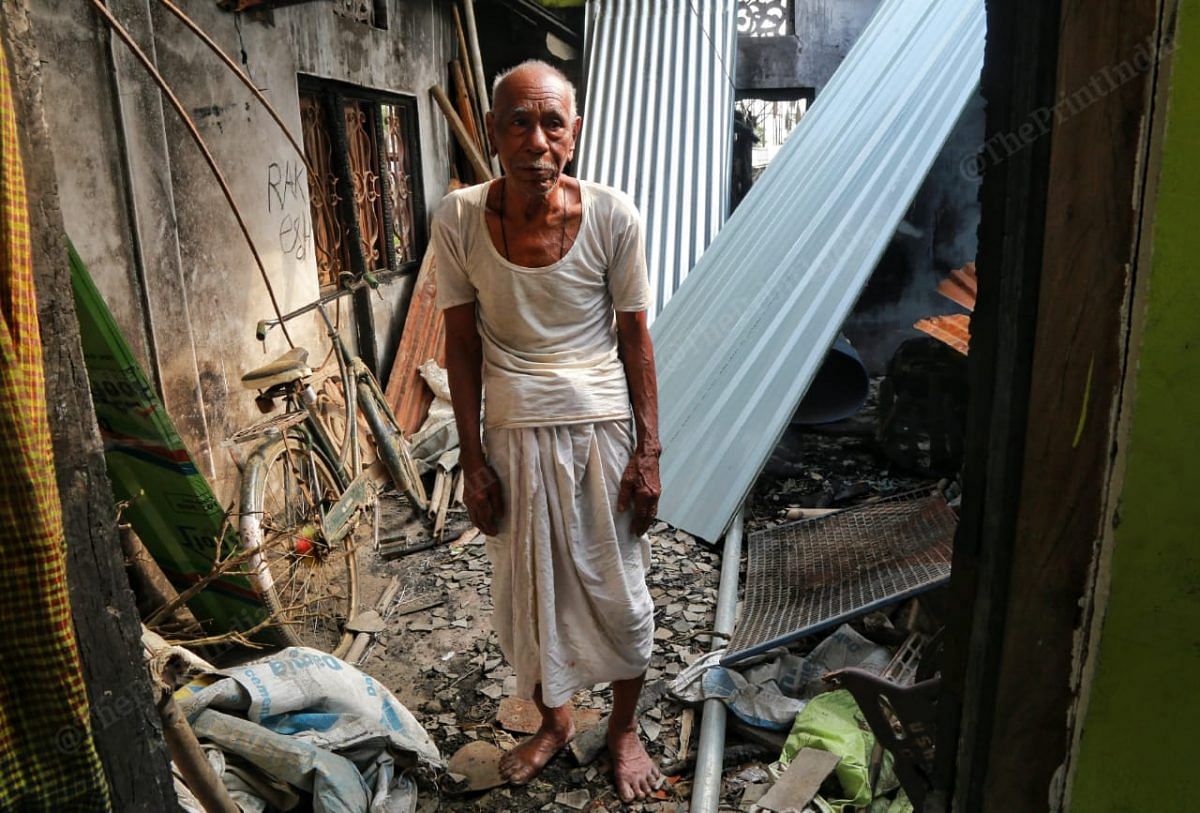 Lombeshwar Saikia shows around the house that was burnt in the fire | Photo: Manisha Mondal | ThePrint