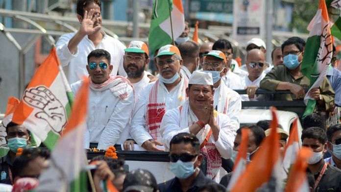 Chhattisgarh CM and Congress leader Bhupesh Baghel (third from left) participates in a roadshow ahead of the Assam assembly polls, in Dibrugarh district, on 24 March 2021 | PTI