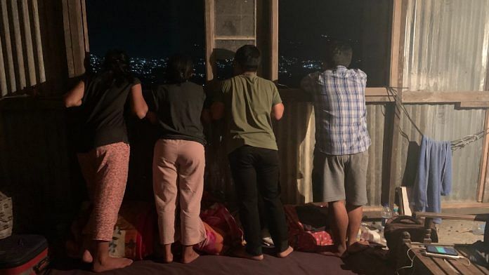 Four Myanmarese refugees, including two policewomen, take in a view of Aizawl, a sea of lights at night, earlier this week | Amrita Nayak Dutta | ThePrint