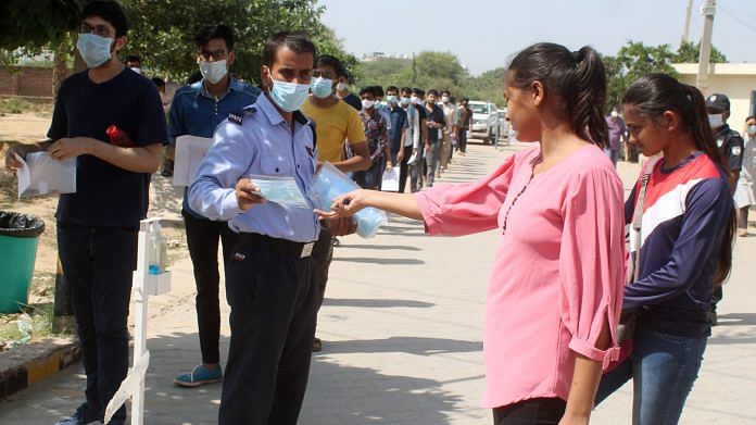 Students being given masks before entering an exam centre for JEE entrance exam in Gurugram, on 27 September 2020 | ANI File Photo