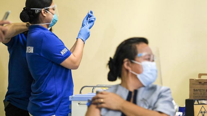 A healthcare worker prepares a dose of China's Sinovac Covid-19 vaccine in Quezon City, Manila on 1 March 2021 | Photo: Veejay Villafranca | Bloomberg