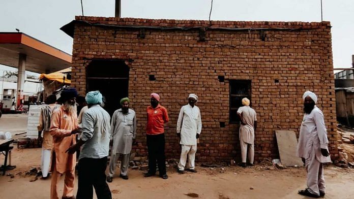 Farmers in front of a concrete structure raised at Tikri border | Shubhangi Misra | ThePrint