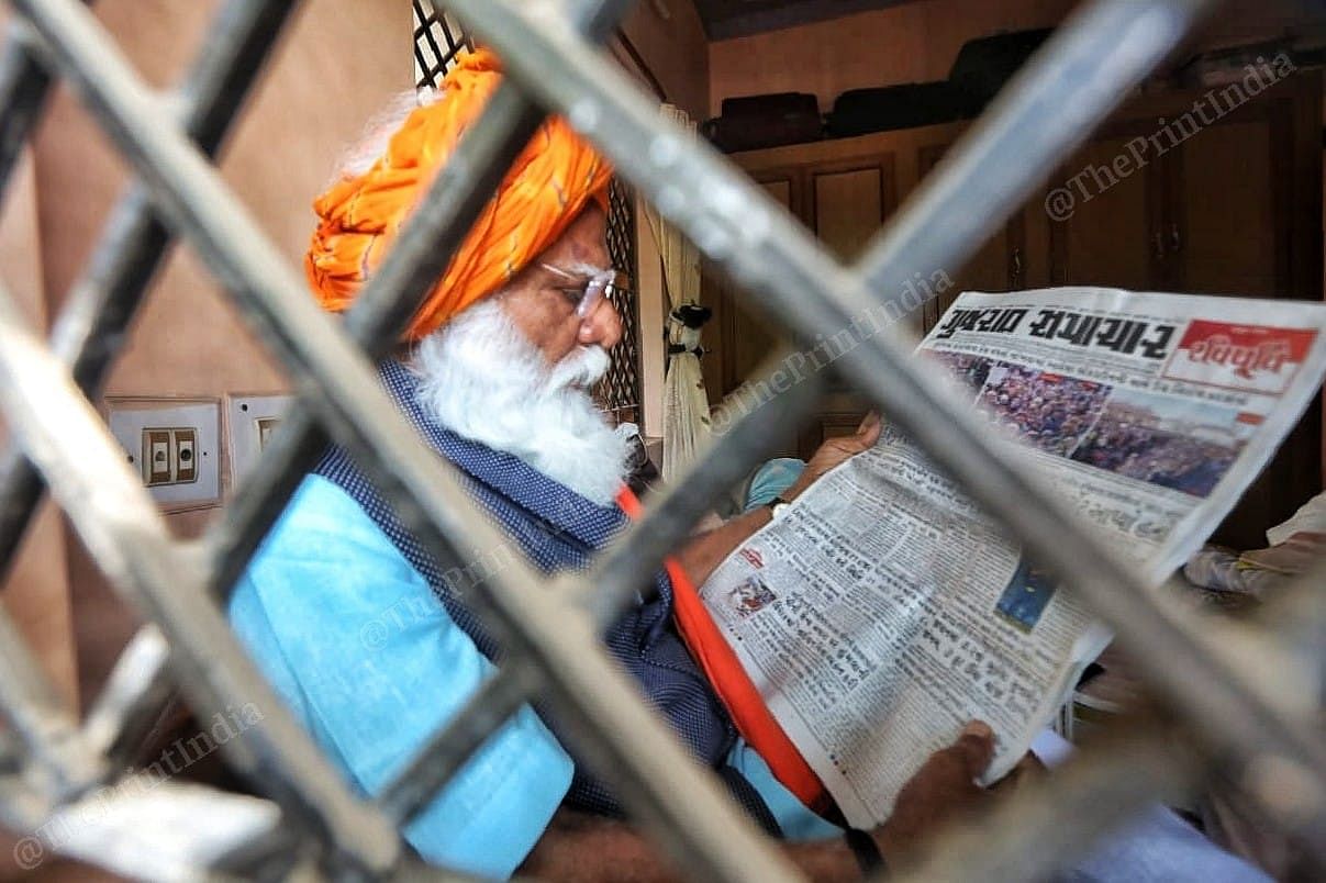 Lalji Devaria reading morning newspaper at his residence in Gandhidham | Photo: Praveen Jain | ThePrint