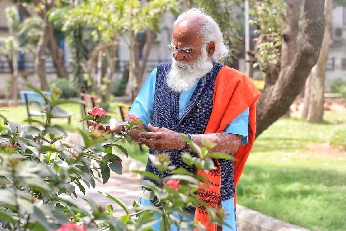 Devaria looks at the flowers in the garden | Photo: Praveen Jain | ThePrint