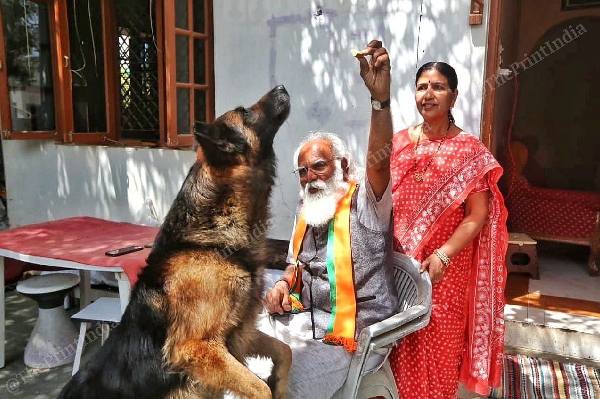 Lalji Devaria plays with his dog Tyson at their house | Photo: Praveen Jain | ThePrint