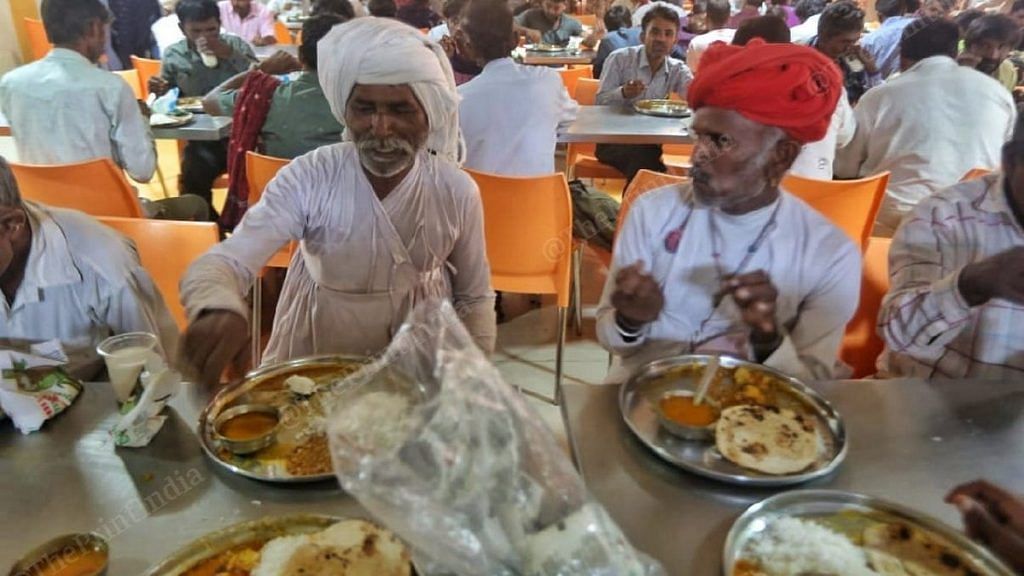 Visiting farmers enjoy a meal at the Unjha APMC canteen | Photo: Praveen Jain | ThePrint
