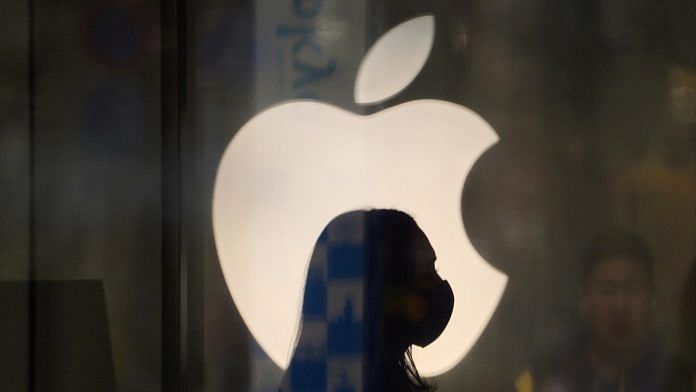 An employee wearing a protective mask in front of an Apple logo | Representational image | Photographer: Toru Hanai | Bloomberg