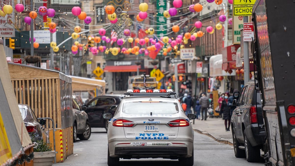 NYPD officers hand out information about hate crimes in Asian communities after mass shootings in Atlanta that left 8 dead, including 6 Asian Americans, on 17 March, 2021 in New York City | Photo by David Dee Delgado/Getty Images via Bloomberg