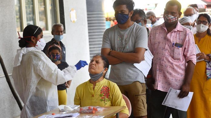 A health worker takes a nasal sample from a woman for Covid-19 test at Goregaon Municipal Maternity Home in Mumbai, on 20 March 2021 | Representational image | PTI