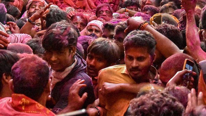 Devotees not adhering to Covid-19 norms during religious procession ahead of Holi in Varanasi on 24 March 2021 | PTI