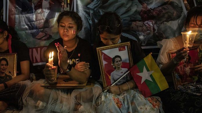 A demonstrator holds an image of Aung San Suu Kyi during a protest outside the UN Building in Bangkok on 4 March | Representational image | Photo: Andre Malerba | Bloomberg