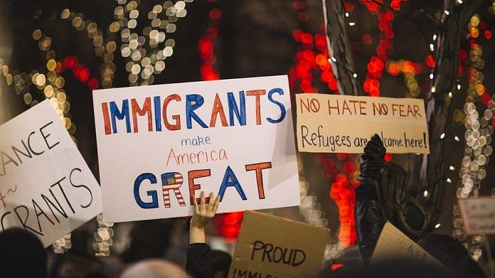 People holding placards calling for pro-immigration policies in the US | Photo: Pixel