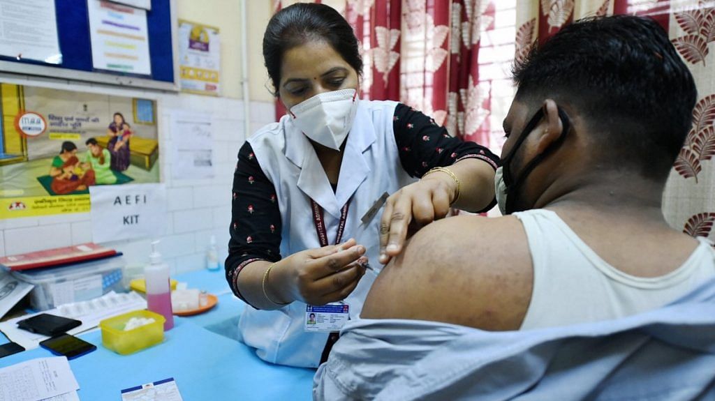 A medic administers the dose of Covid-19 vaccine to a frontline worker during an inoculation drive at a vaccination camp in Old Delhi, on 20 March 2021 | Representational image | PTI